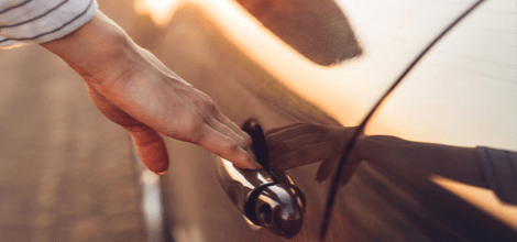 hand reaching to open car door 